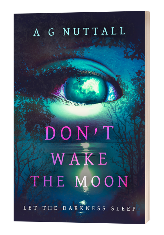Cover of the book ‘Don’t Wake the Moon’ by A G Nuttall. A surreal, teal and purple-toned design shows a large, glowing eye seamlessly blended into a moonlit night sky over a dark lake surrounded by trees. The title is in bold pink letters, with the tagline ‘Let the Darkness Sleep’ at the bottom.